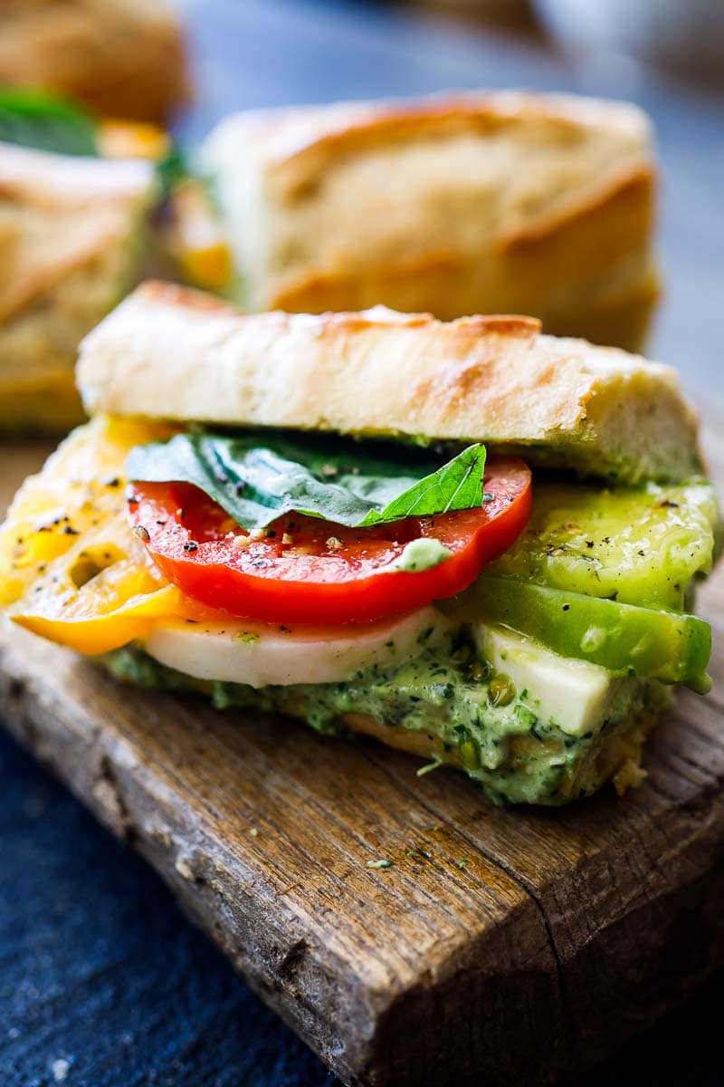 These Caprese Sandwiches are the perfect summer lunch- made with juicy ripe tomatoes, fresh mozzarella cheese, fresh basil, and  pest0-mayo on a baguette, they are great made ahead or packed for picnic lunches on the go. 