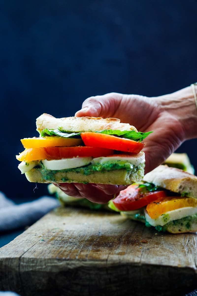 These Caprese Sandwiches are the perfect summer lunch- made with juicy ripe tomatoes, fresh mozzarella cheese, fresh basil, and  pest0-mayo on a baguette, they are great made ahead or packed for picnic lunches on the go. 