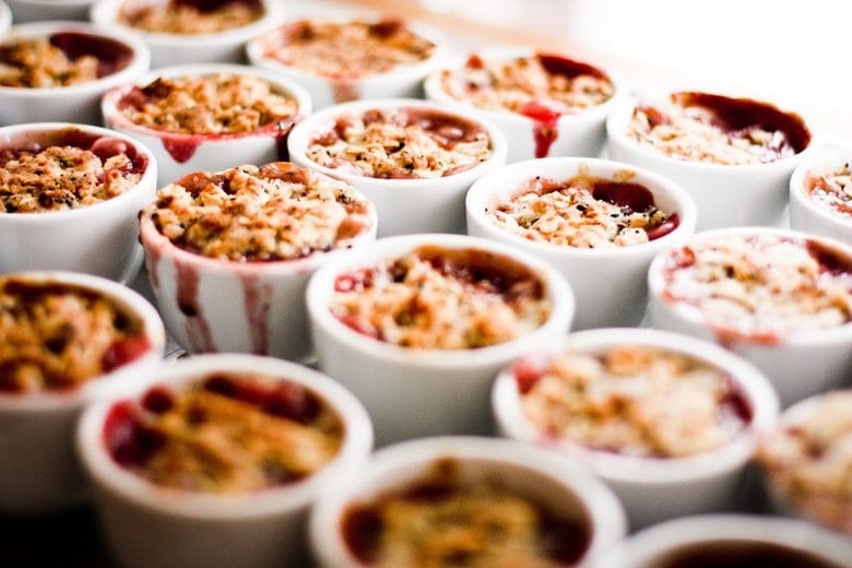 A simple dessert for entertaining -Mini Pear and Berry Crumbles with optional Nigella seed, that can be made in advance in mini porcelain cups.