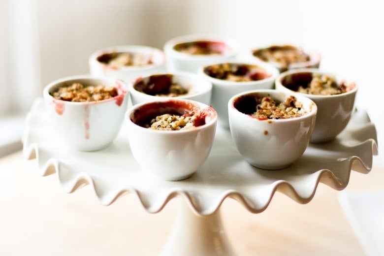 A simple dessert for entertaining -Mini Pear and Berry Crumbles with optional Nigella seed, that can be made in advance in mini porcelain cups.