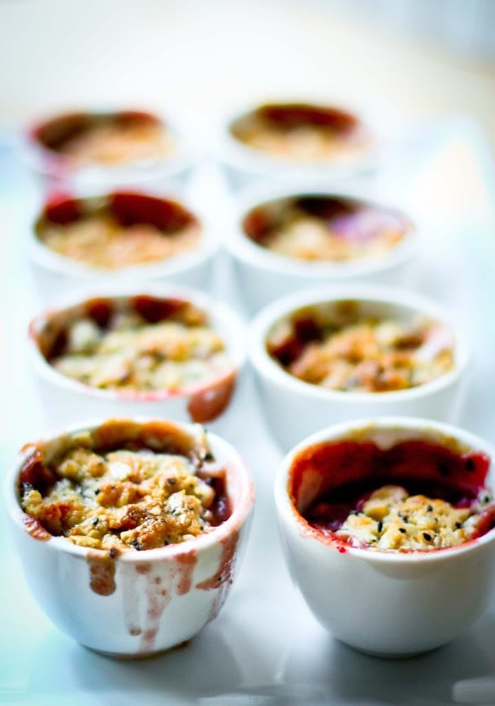 A simple dessert for entertaining -Mini Pear and Berry Crumbles with optional Nigella seed, that can be made in advance in mini porcelain cups. | www.feastingathome.com