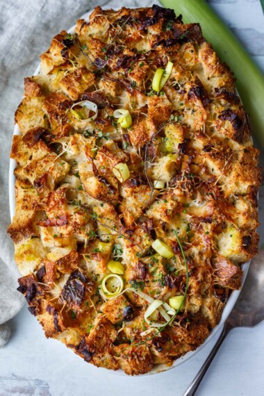 savory leek bread pudding in an oval baking dish.
