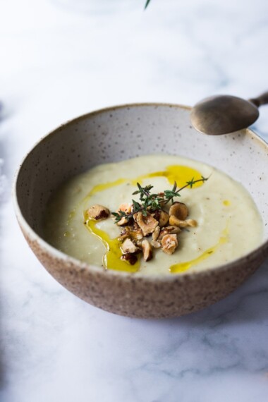 Parsnip Soup with hazelnuts, cardamom and thyme. A simple soup that can be made on the stovetop or roasted in the oven. Vegan Adaptable. #parsnipsoup #parsniprecipes #parsnips