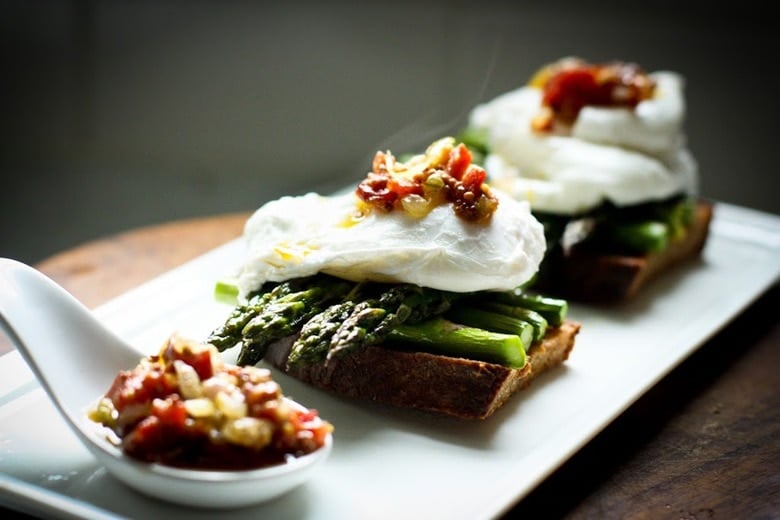 A simple breakfast- Roasted asparagus on toast with poached eggs and a warm bacon mustard vinaigrette. Or make this for dinner! | www.feastingathome.com