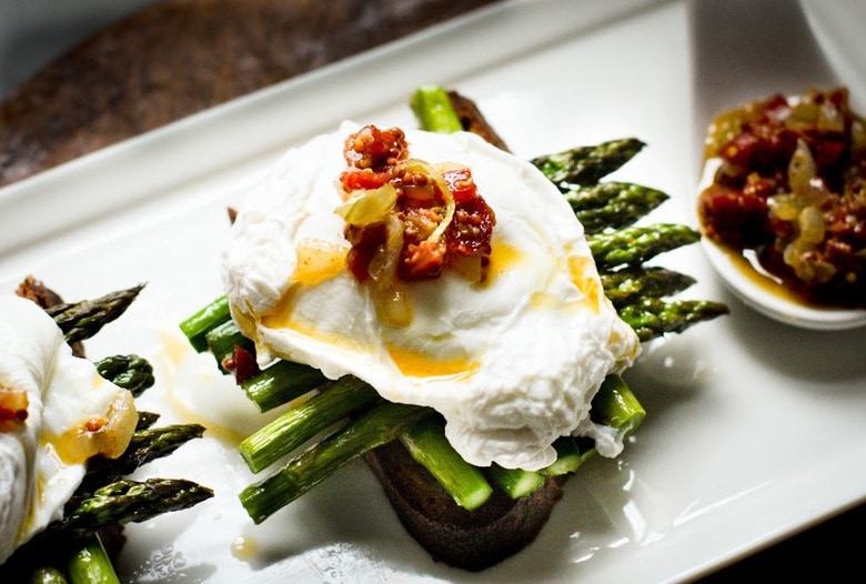 A simple breakfast- Roasted asparagus on toast with poached eggs and a warm bacon vinaigrette. Or make this for dinner! | www.feastingathome.com