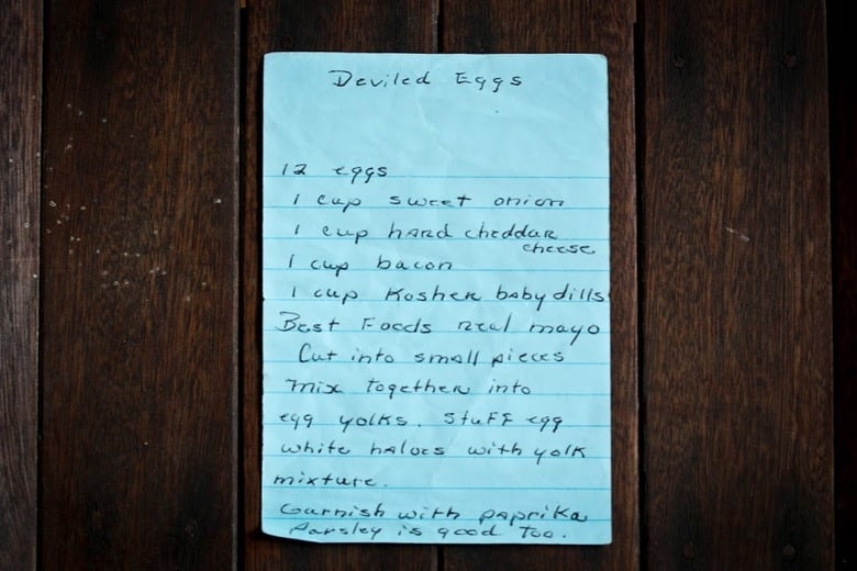 A simple delicious recipe for the Best EVER Deviled Eggs- Made with crumbled bacon, cheddar and onion. | www.feastingathome.com