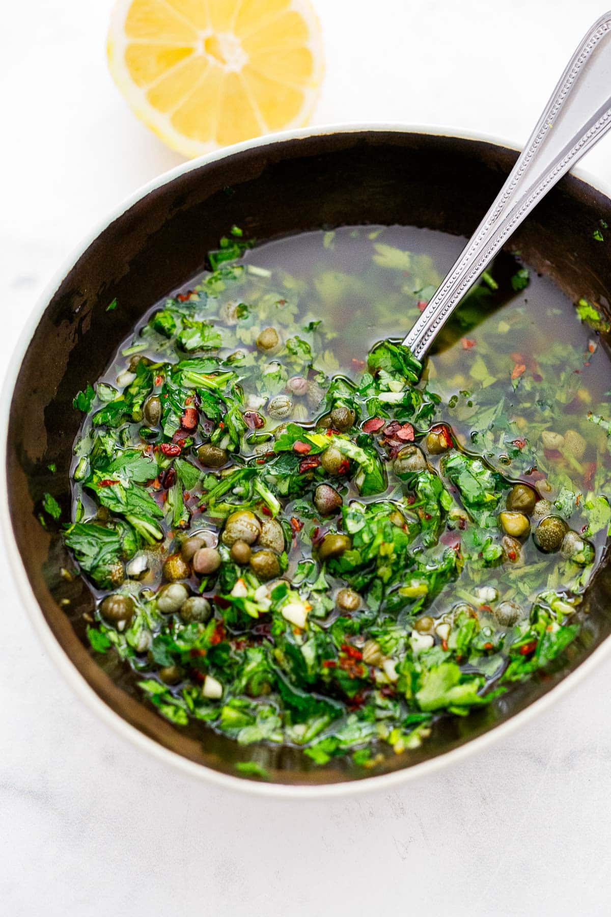 serving bowl with Italian salsa verde made with parsley and capers.