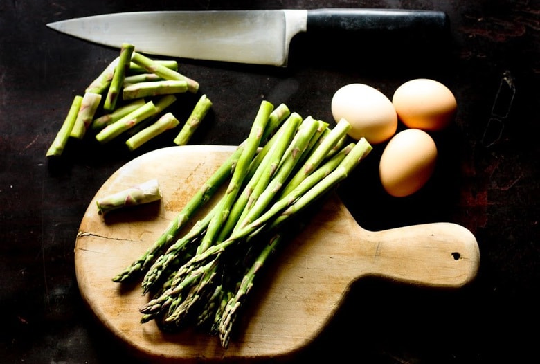 A simple breakfast- Roasted asparagus on toast with poached eggs and a warm bacon vinaigrette. Or make this for dinner! | www.feastingathome.com