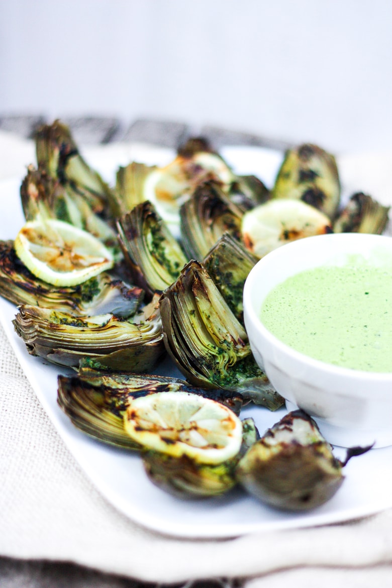 A recipe for Grilled Artichokes with EASY step-by-step instructions, served with Herbed Oil and optional Basil Aioli. Vegan adapatable! 