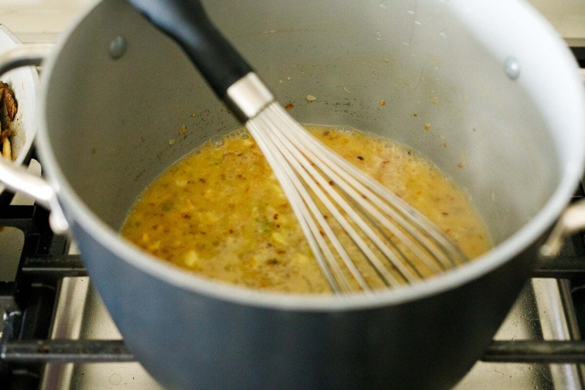 whisking in the pasta water and miso paste. 