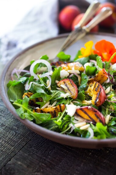 Grilled Peach and Arugula Salad with basil and a White Balsamic Vinaigrette -a simple tasty recipe using fresh seasonal peaches! #peachsalad #peaches #arugula #peacharugulasalad