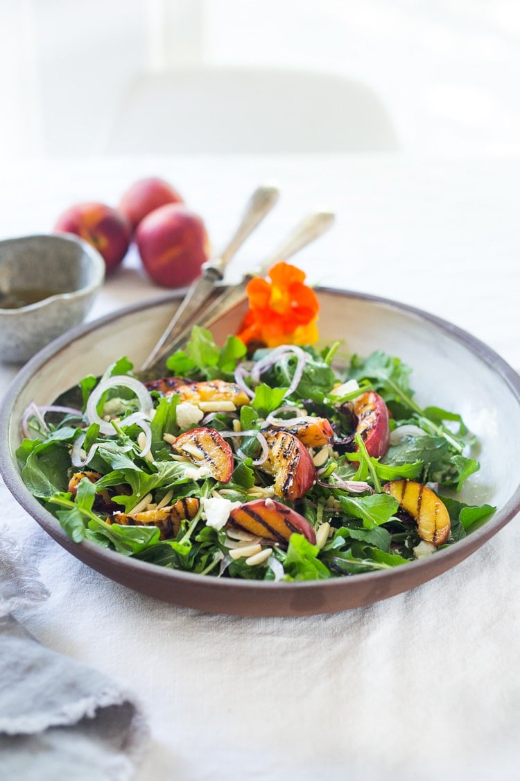 Grilled Peach and Arugula Salad with basil and a White Balsamic Vinaigrette -a simple tasty recipe using fresh seasonal peaches! #peachsalad #peaches #arugula #peacharugulasalad 