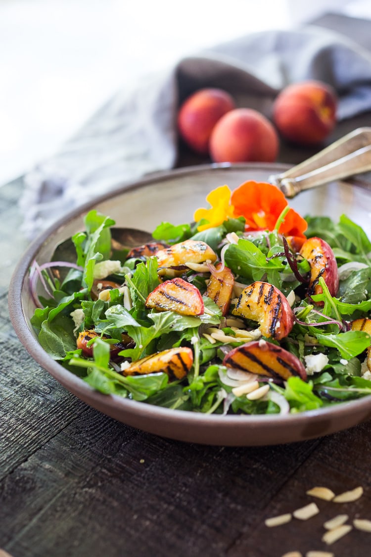 Grilled Peach and Arugula Salad with basil and a White Balsamic Vinaigrette -a simple tasty recipe using fresh seasonal peaches! #peachsalad #peaches #arugula #peacharugulasalad 