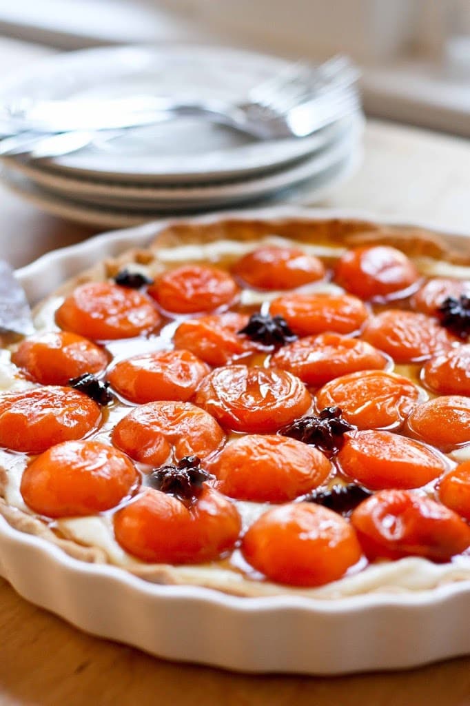 This Apricot Tart is one of my favorite summer desserts. A Pate Sucree crust holds a creamy mascarpone filling topped with honey-roasted apricots infused with a whisper of star anise.