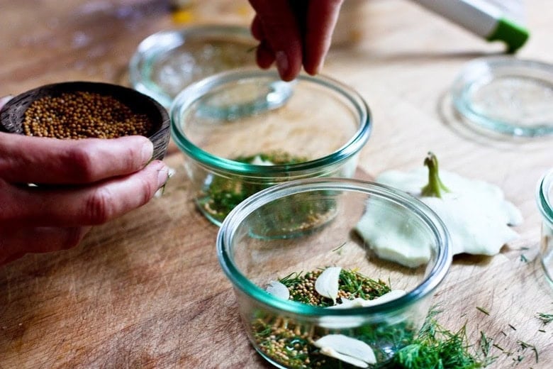 filling the jars with seeds and garlic.