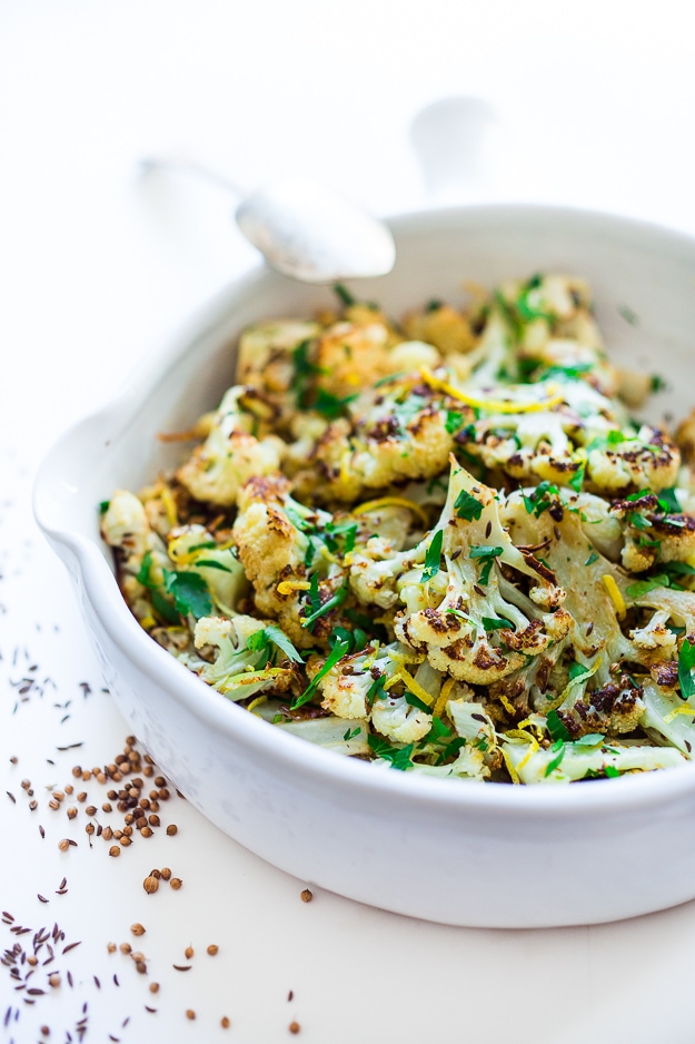 Roasted Cauliflower with garlic, lemon, parsley and coriander seeds - a simple vegan side dish that is full of flavor! Vegan and gluten free! |www.feastingathome.com #roastedcauliflower #cauliflower #vegansidedish 
