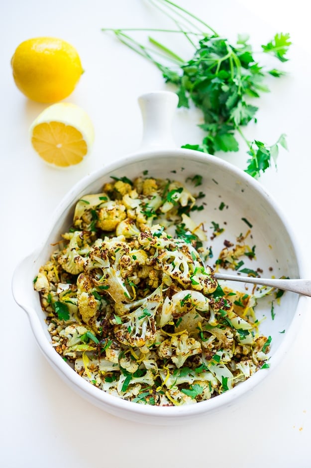 Roasted Cauliflower with garlic, lemon, parsley and coriander seeds - a simple vegan side dish that is full of flavor! Vegan and gluten free! |www.feastingathome.com #roastedcauliflower #cauliflower #vegansidedish 