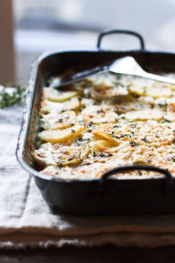 Parsnip Gratin with Gruyere and Thyme- a deliciously decadent side dish, perfect for the holiday table! | www.feastingathome.com