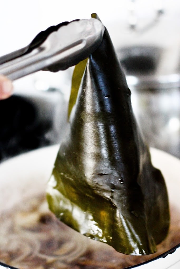 tongs picking Kombu out of the broth