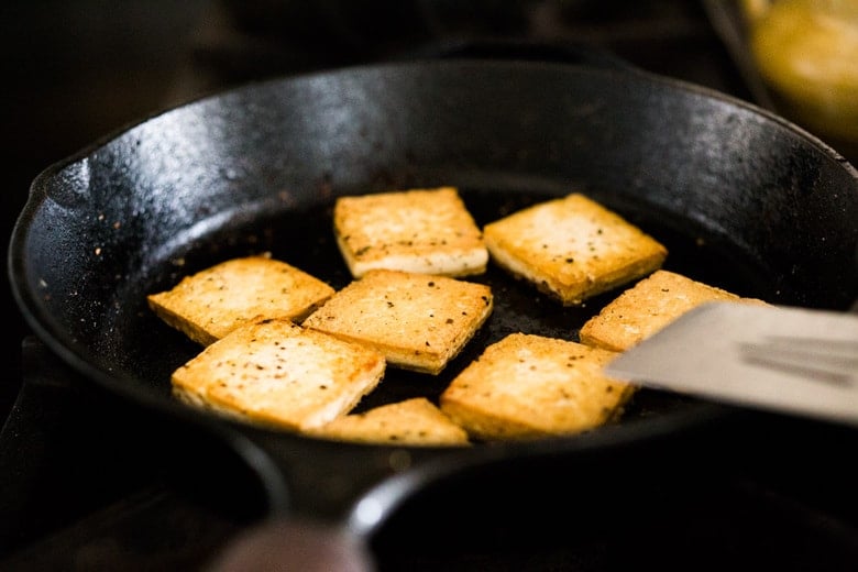 cooking crispy tofu in a skillet