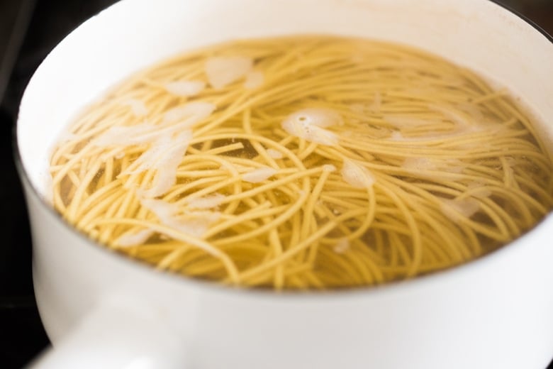 cooking the ramen noodles in a pot of water