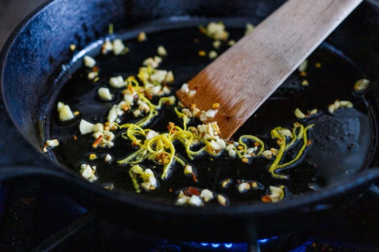 garlic, chili flakes and lemon zest sautéing in a pan