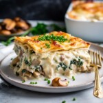 A delicious recipe for creamy Chicken Lasagna with mushrooms, spinach and rosemary layered with a creamy bechamel sauce. Vegetarian-adaptable. See notes for making ahead.