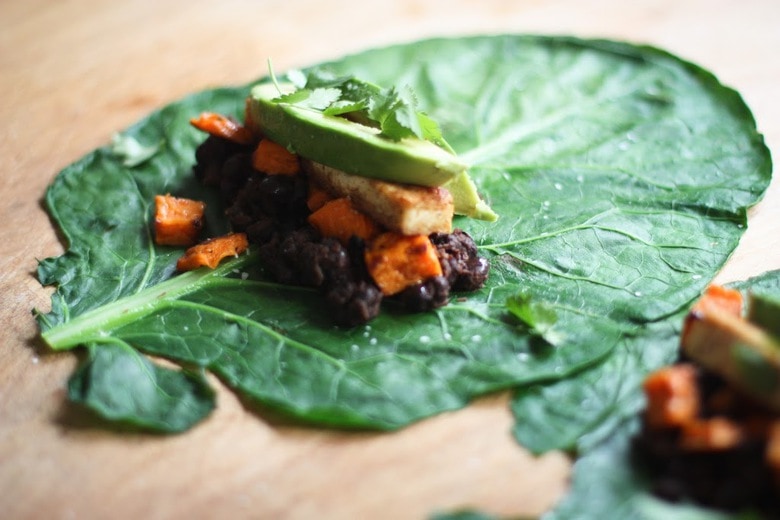 Healthy Vegan Collard Green Wraps - served up burrito-style with roasted sweet potatoes, tofu, chipotle black beans, avocado and a delicious Chipotle Lime dressing. Vegan and Gluten free! #collardgreens #collardgreenwraps #collardgreenburritos #veganburrito #glutenfreeburrito