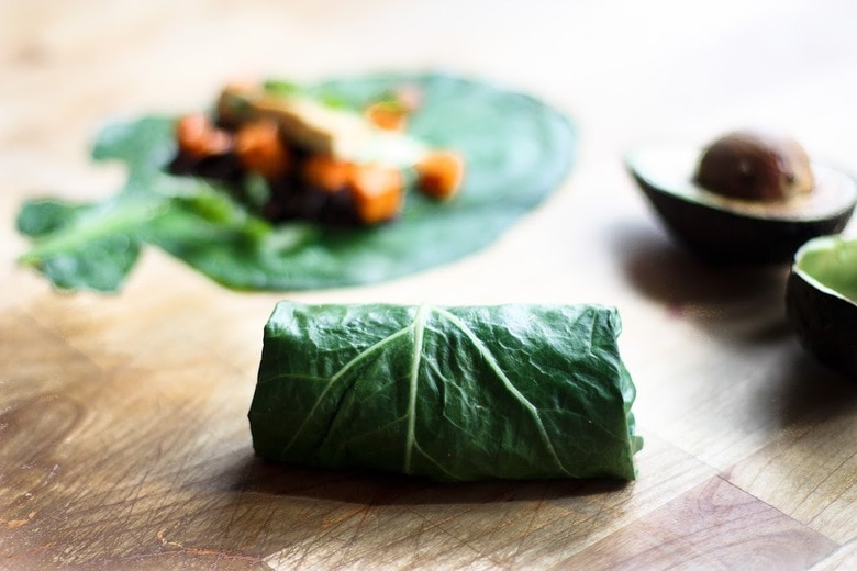Healthy Vegan Collard Green Wraps - served up burrito-style with roasted sweet potatoes, tofu, chipotle black beans, avocado and a delicious Chipotle Lime dressing. Vegan and Gluten free! #collardgreens #collardgreenwraps #collardgreenburritos #veganburrito #glutenfreeburrito