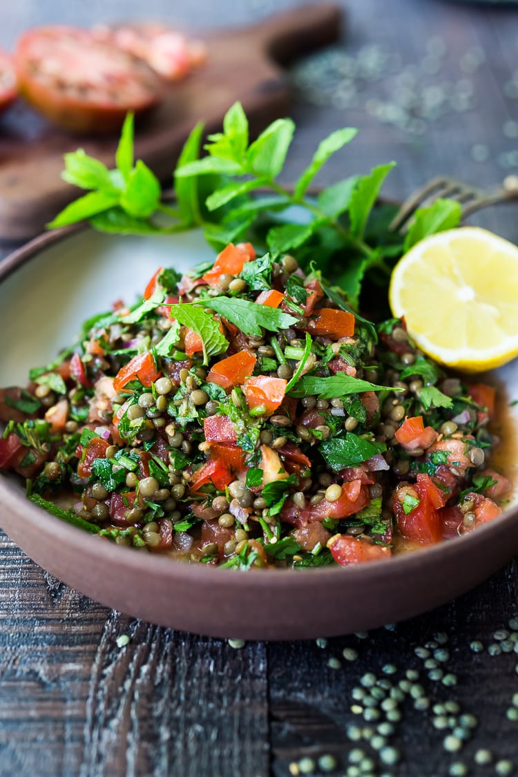 This Simple Lentil Tabouli Salad is full of Middle Eastern flavor! Filling lentils are paired with summer  tomatoes, lemon, mint and parsley and a unique combination of spices, and keeps for several days, perfect for midweek lunches or potlucks! Vegan and Gluten-Free #tabouli #lentil #lentils #lentilsalad #lentiltabouli #lentiltabbouleh #tabbouleh #vegan #salad #glutenfree