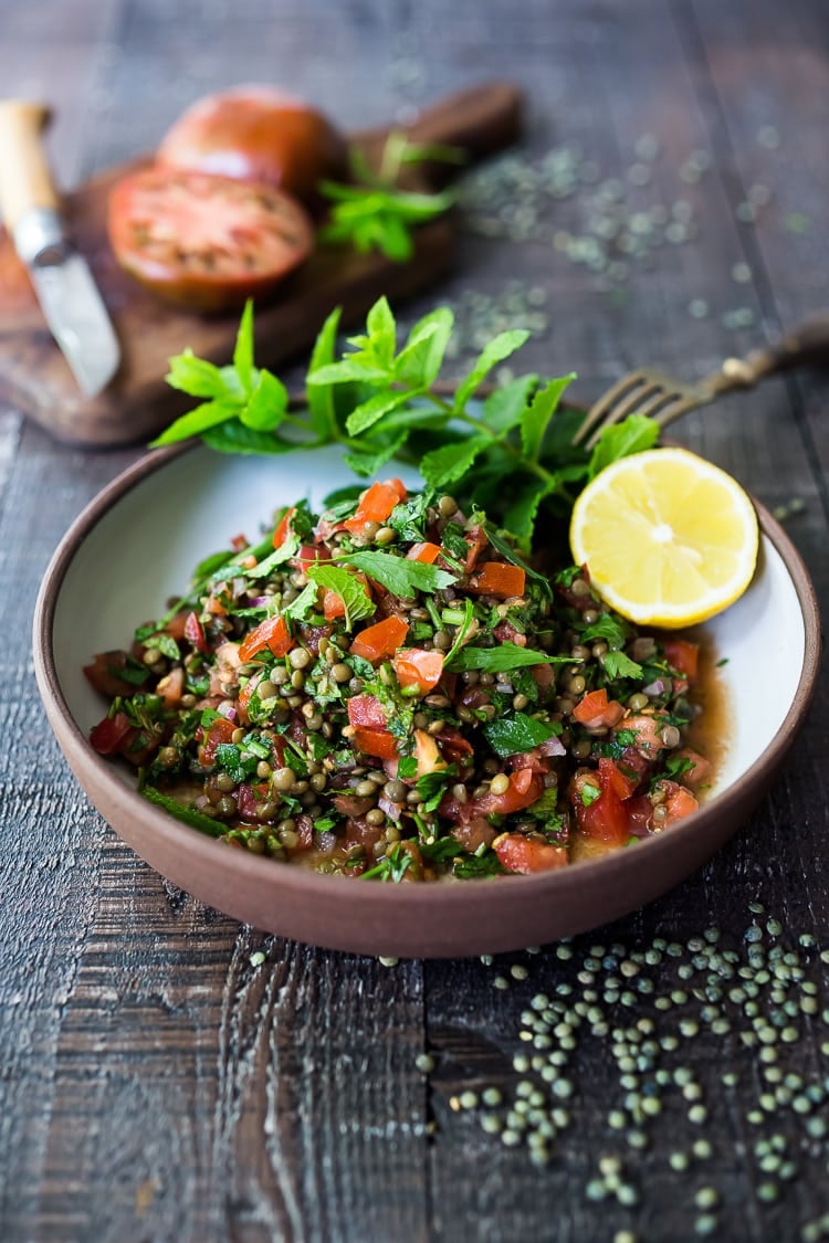 This Simple Lentil Tabouli Salad is full of Middle Eastern flavor! Filling lentils are paired with summer  tomatoes, lemon, mint and parsley and a unique combination of spices, and keeps for several days, perfect for midweek lunches or potlucks! Vegan and Gluten-Free #tabouli #lentil #lentils #lentilsalad #lentiltabouli #lentiltabbouleh #tabbouleh #vegan #salad #glutenfree