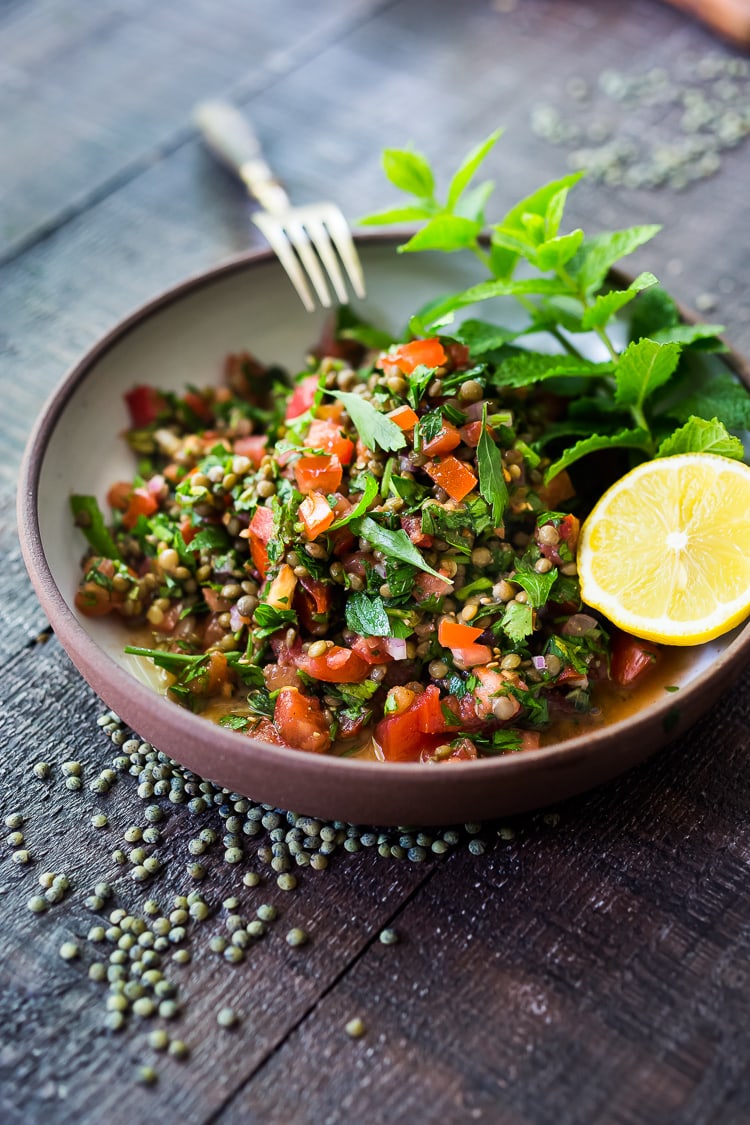 This Simple Lentil Tabouli Salad is full of Middle Eastern flavor! Filling lentils are paired with summer  tomatoes, lemon, mint and parsley and a unique combination of spices, and keeps for several days, perfect for midweek lunches or potlucks! Vegan and Gluten-Free #tabouli #lentil #lentils #lentilsalad #lentiltabouli #lentiltabbouleh #tabbouleh #vegan #salad #glutenfree