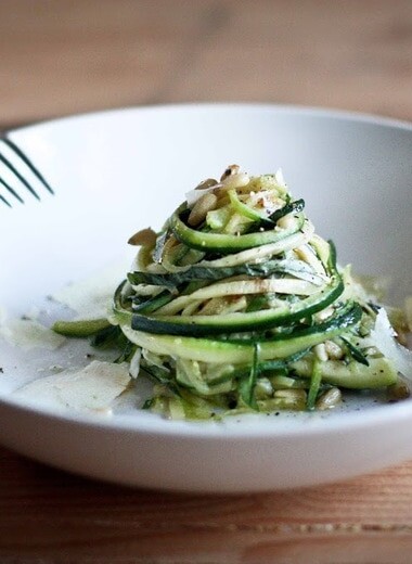 Zucchini Linguine with garlic, olive oil, toasted pine nuts, basil ribbons & shaved pecorino cheese, a simple delicious GF meal,made w/ Zucchini "noodles"! | www.feastingathome.com #zoodles #zucchininoodles #lowcarb #zucchini #spiralized