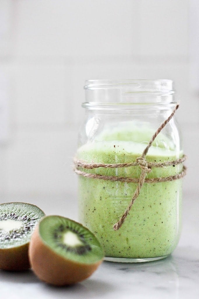 This Kiwi Smoothie is sure to brighten your day! Made with banana, avocado, and spinach, it's sweet and tart, and deliciously addicting. Vegan!