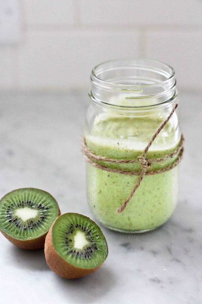 A simple tasty recipe for Avocado Smoothie with Kiwi and lime, sweetened with honey ( or agave). Deliciously addicting and easy to make! | www.feastingathome.com