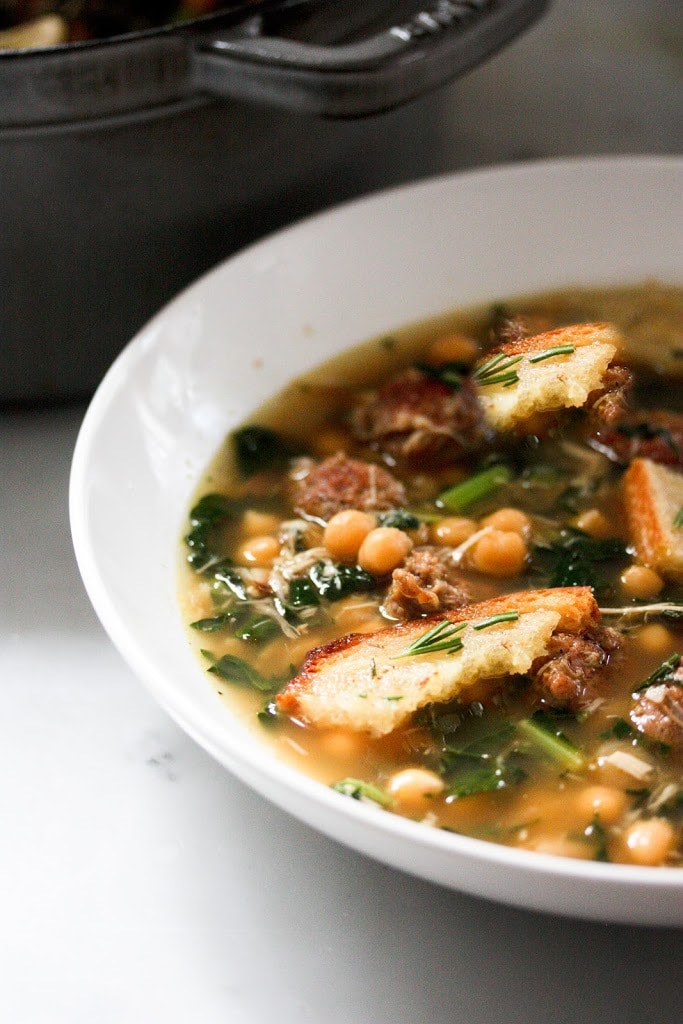 A brothy healing soup - Kale, chickpea and chicken soup with a toasty rosemary crouton. Simple and delicious. | www.feastingathome.com