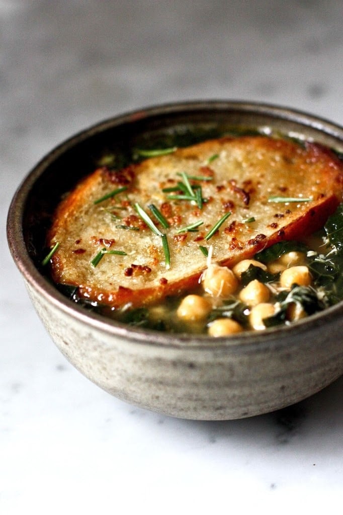 A brothy healing soup - Kale, chickpea and chicken soup with a toasty rosemary crouton. Simple and delicious. | www.feastingathome.com