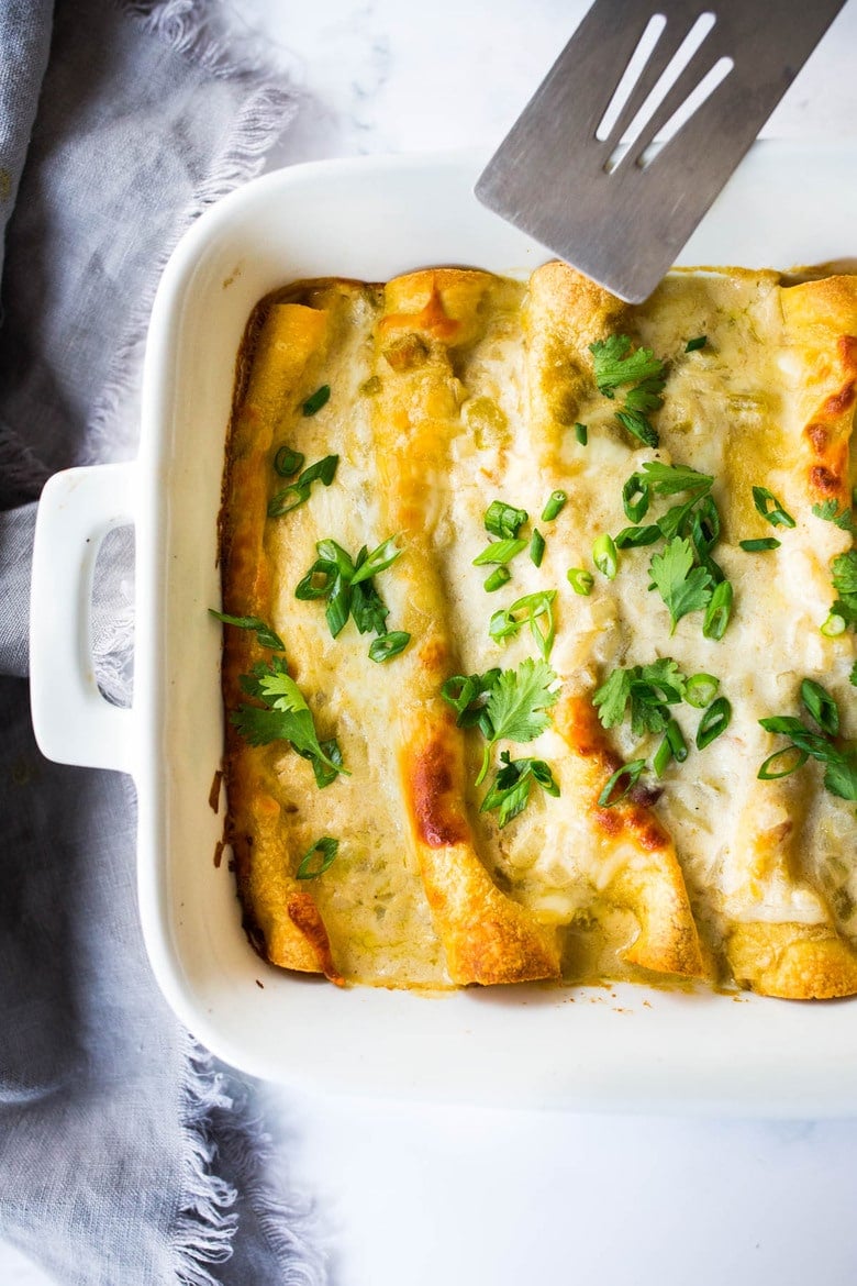 White Chicken Enchiladas with Creamy Poblano Sauce- an easy, delicious comfort food meal. These creamy chicken enchiladas will not disappoint! #whitechickenenchiladas #chickenenchiladas #creamychickenenchiladas #enchiladas #comfortfood