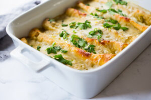 Creamy Chicken Enchiladas with Creamy Poblano Sauce- an easy, delicious comfort food meal. These creamy chicken enchiladas will not disappoint! #whitechickenenchiladas #chickenenchiladas #creamychickenenchiladas #enchiladas #comfortfood