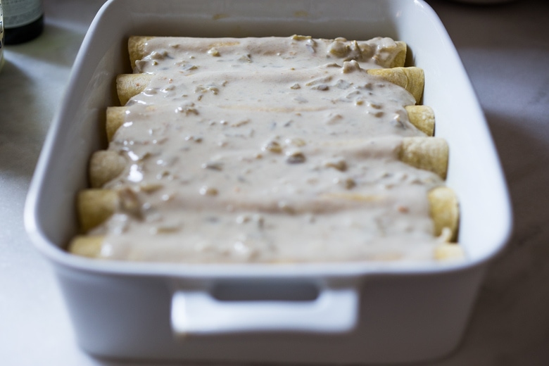 White Chicken Enchiladas with Creamy Poblano Sauce- an easy, delicious comfort food meal. These creamy chicken enchiladas will not disappoint! #whitechickenenchiladas #chickenenchiladas #creamychickenenchiladas #enchiladas #comfortfood