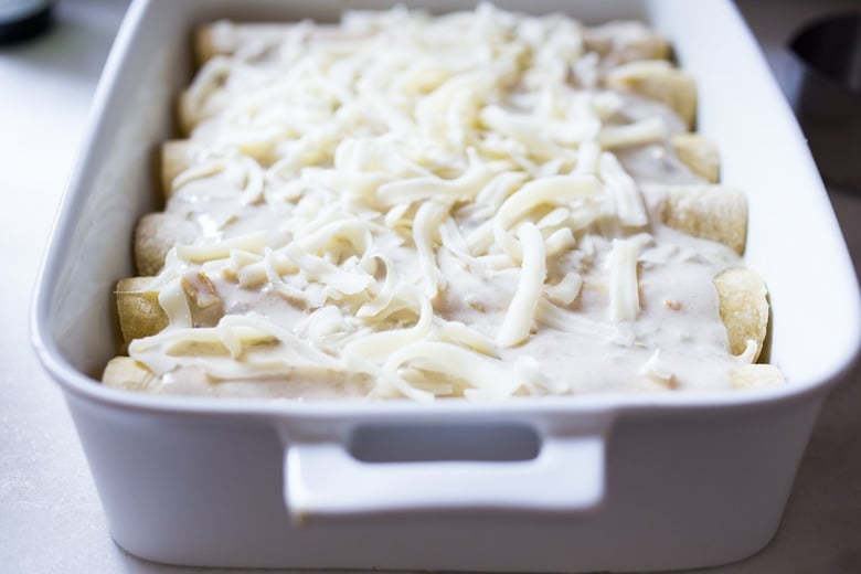 White Chicken Enchiladas with Creamy Poblano Sauce- an easy, delicious comfort food meal. These creamy chicken enchiladas will not disappoint! #whitechickenenchiladas #chickenenchiladas #creamychickenenchiladas #enchiladas #comfortfood