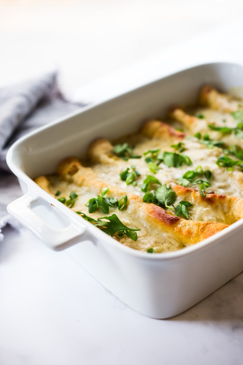 White Chicken Enchiladas with Creamy Poblano Sauce- an easy, delicious comfort food meal. These creamy chicken enchiladas will not disappoint! #whitechickenenchiladas #chickenenchiladas #creamychickenenchiladas #enchiladas #comfortfood