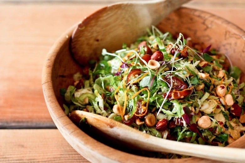A simple tasty recipe for raw Brussel Sprout Salad with Hazelnuts and dates, vegan, healthy and a great combination of flavors. | www.feastingathome.com