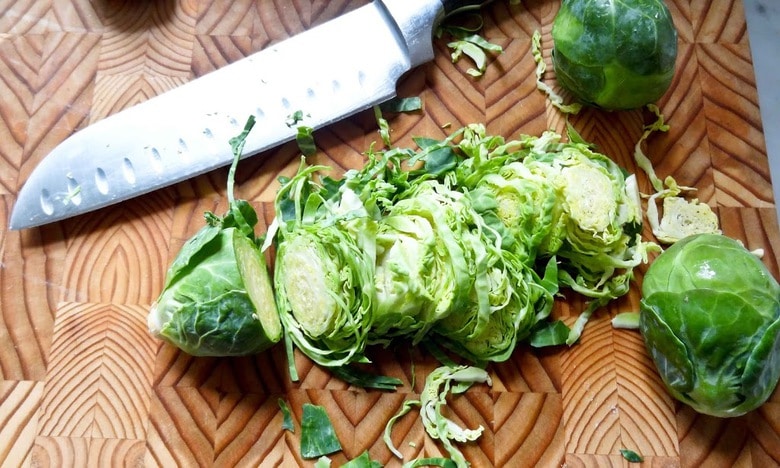 Brussel Sprout Salad with Hazelnuts and Dates! This easy healthy vegan salad has a delicious combination of flavors and can be made ahead! | www.feastingathome.com #brusselsproutsalad #brusselsprouts #vegansalad #dates #brusselsproutslaw #shreddedbrusselsprouts