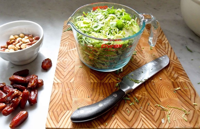 Brussel Sprout Salad with Hazelnuts and Dates! This easy healthy vegan salad has a delicious combination of flavors and can be made ahead! | www.feastingathome.com #brusselsproutsalad #brusselsprouts #vegansalad #dates #brusselsproutslaw #shreddedbrusselsprouts