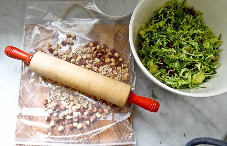 Brussel Sprout Salad with Hazelnuts and Dates! This easy healthy vegan salad has a delicious combination of flavors and can be made ahead! | www.feastingathome.com #brusselsproutsalad #brusselsprouts #vegansalad #dates #brusselsproutslaw #shreddedbrusselsprouts