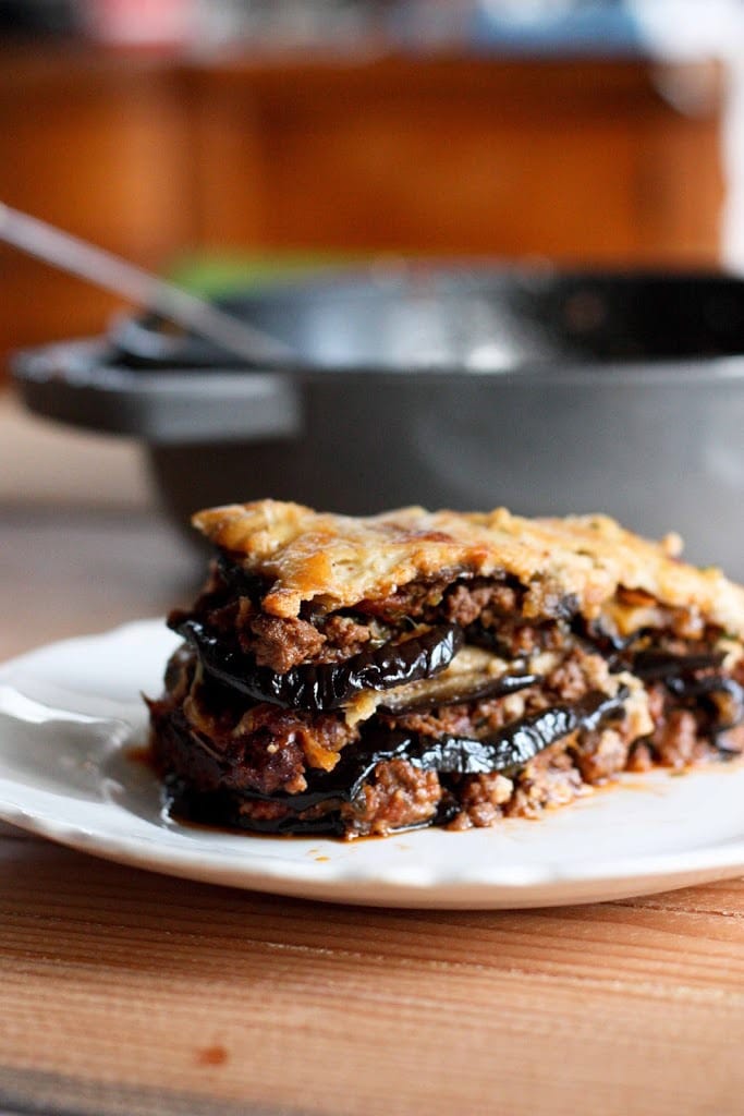 An authentic, delicious recipe for Eggplant Moussaka- with a Tomato lamb sauce, and creamy béchamel sauce. Vegetarian Adaptable! Can be made ahead and baked prior to serving. 