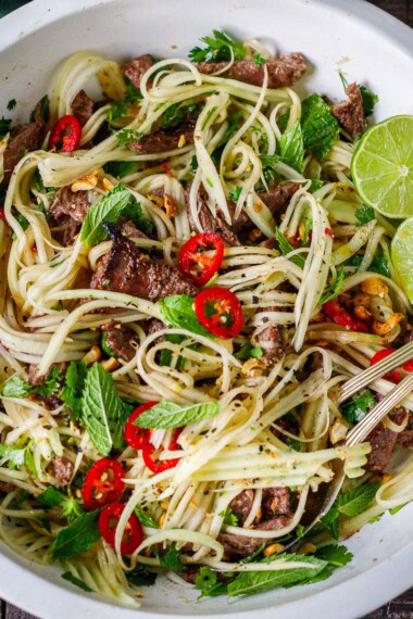 This Vietnamese Green Papaya Salad is topped with tender grilled lemongrass beef, fresh herbs, and tangy Nuoc Cham dressing for a fresh, flavorful, protein-packed meal. 