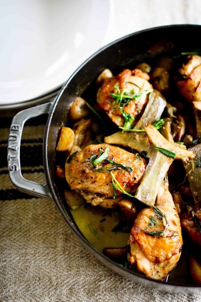 Our favorite Braised Chicken Thigh Recipes:  Crispy Braised Chicken Thighs with Artichoke hearts, leeks, potatoes and tarragon- a delicious, French-inspired one-pan recipe perfect for spring!
