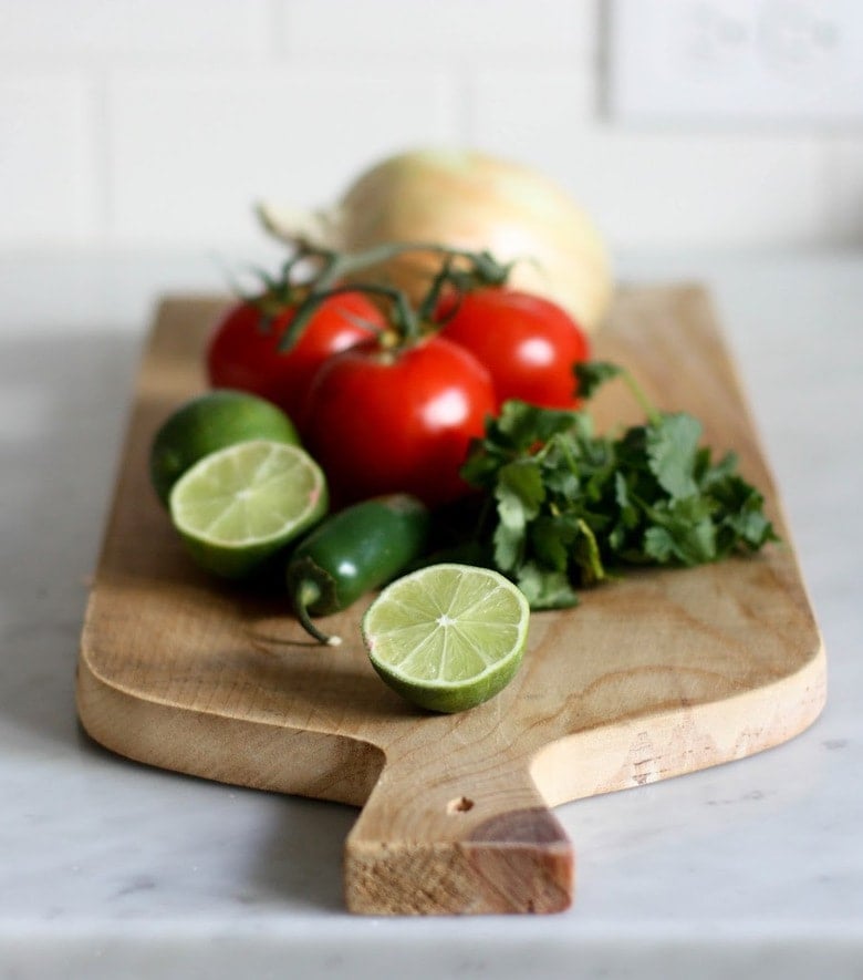 Pico De Gallo ingredients on a cutting board.